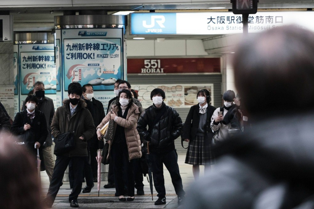 Pedestrians wait to cross a road in Osaka. For years wages have been slow to grow in Japan. Photo: Bloomberg