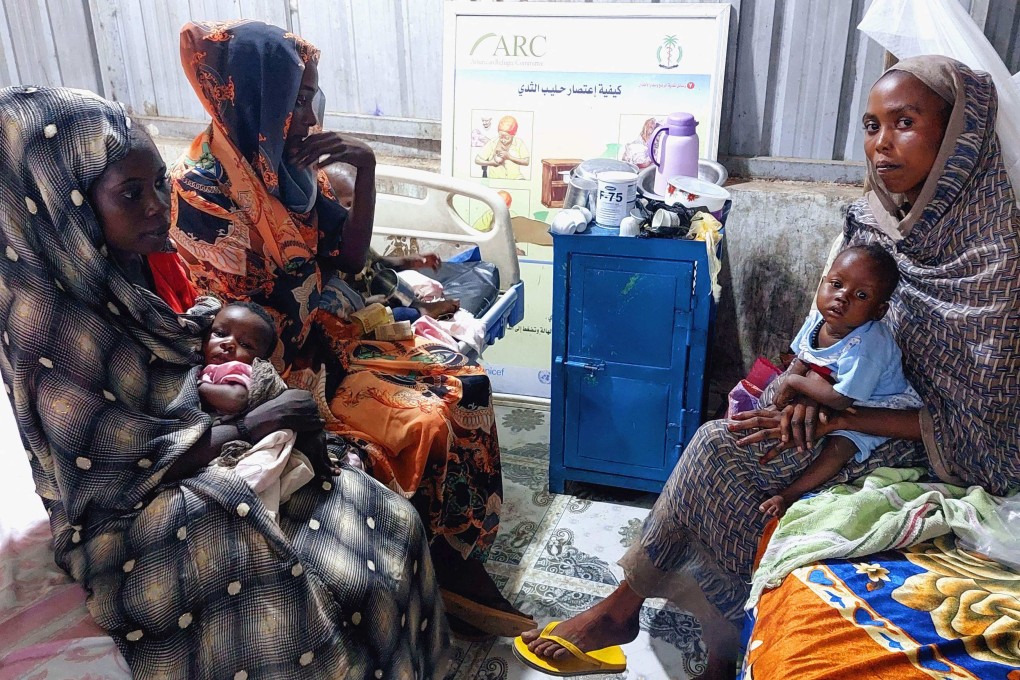 Women and children wait at a nutrition centre at the Kalma camp for the displaced just outside Nyala, the provincial capital of South Darfur state, in November 2022. Photo: AFP
