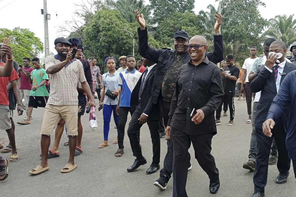 Peter Obi (wearing glasses), presidential candidate of the Labour Party, heads to a polling station on Saturday. Photo: via Xinhua