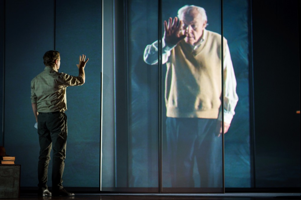 A scene from “The Book of Water” featuring Samuel West (live on stage) and his father, Timothy West (in a pre-recorded video), a polished multimedia spectacle about natural disaster and personal renewal performed in Hong Kong as part of the Hong Kong Arts Festival. Photo: Michel Schnater