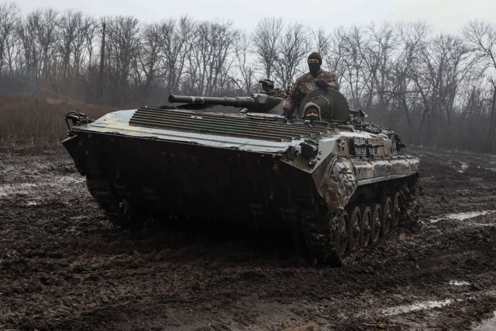 Ukrainian service members ride inside an infantry fighting vehicle near the front line town of Bakhmut, Donetsk region. Photo: Reuters