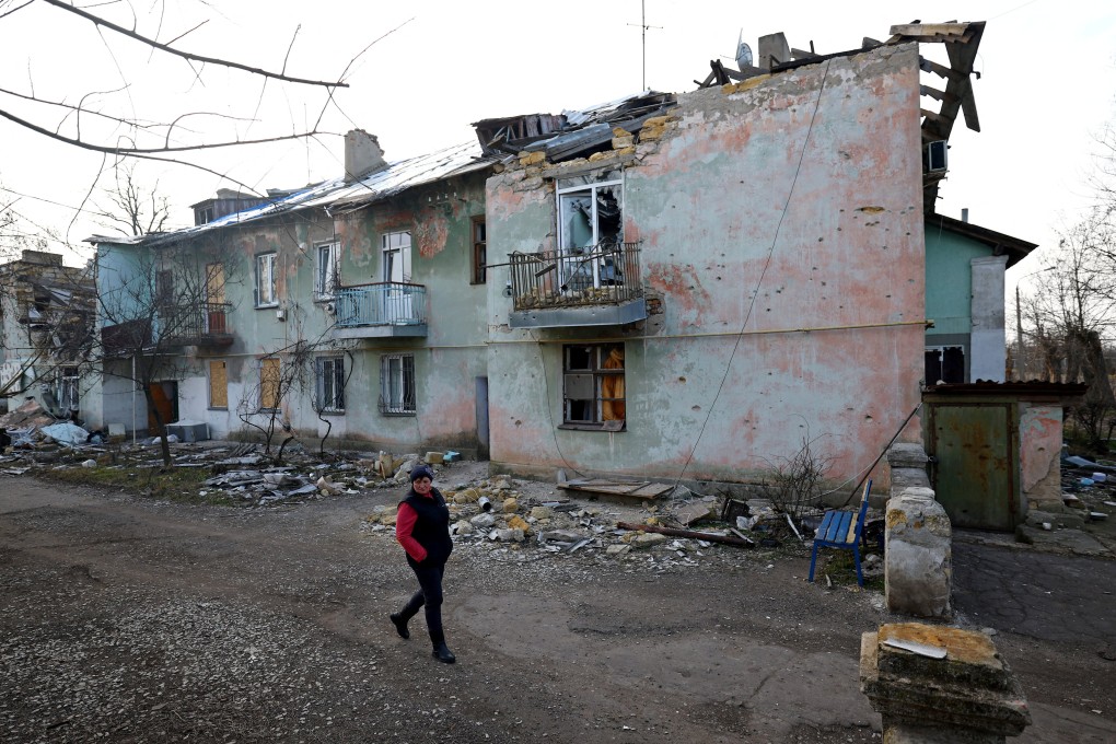 Ukrainian Svitlana Gynzhul walks in front of a damaged house in her village, devastated by shelling at the beginning of Russia’s invasion of Ukraine, in Luch, Mykolaiv region, Ukraine, on February 25. The world is simmering with conflict and resentment. All that’s missing to spark wider war is a trigger. Photo: Reuters