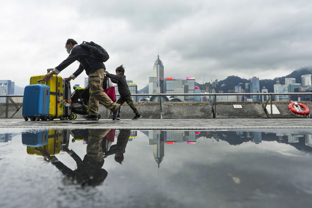 A man and child push their luggage along the Tsim Sha Tsui promenade on January 10. Photo: Elson Li