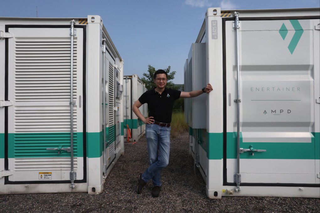AMPD Energy CEO Brandon Ng with an AMPD energy storage system in the Tseung Kwan O Industrial Estate. Photo: Jonathan Wong