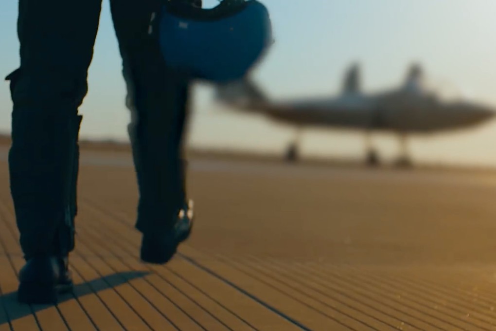 A Chinese navy recruitment video shows a pilot walking towards the blurry figure of an unidentified aircraft. Photo: Weibo