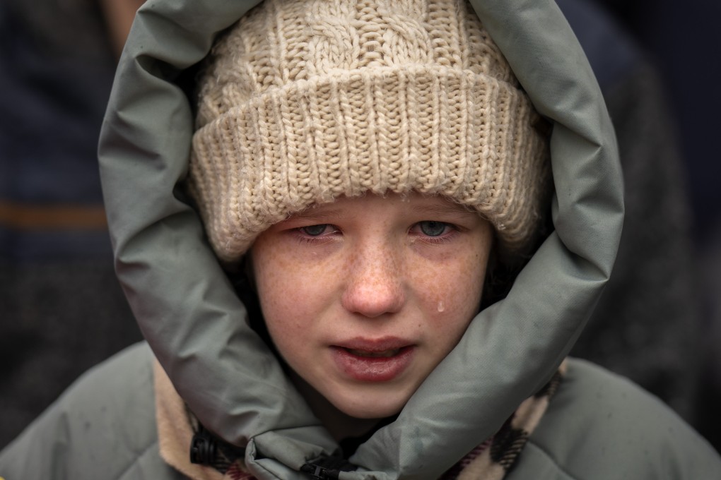 Anna, 10, cries during the funeral of her brother Yurii, 27,  near Kyiv in February. Photo: AP