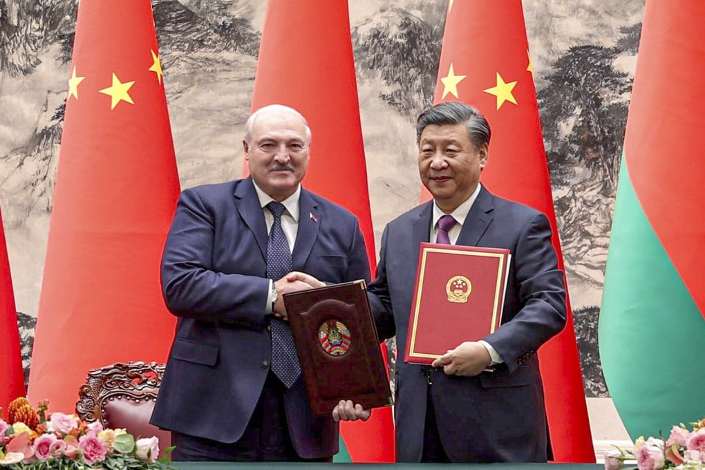 Belarusian President Aleksandr Lukashenko (left) and Chinese President Xi Jinping exchange signed documents in Beijing. Photo: EPA