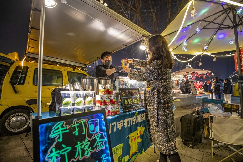 A street vendor sells drinks last month in China’s Chongqing municipality, which has implemented a variety of nighttime activities this year to boost the so-called night economy. Photo: Xinhua
