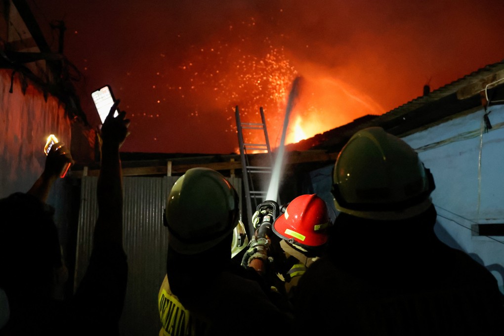 Firefighters battle a massive blaze at a fuel storage station in Jakarta, Indonesia on Friday. Photo: Reuters