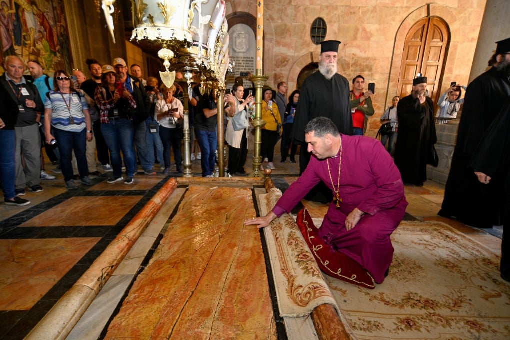 Anglican Archbishop of Jerusalem Hosam Elias Naoum kneels at the Stone of Unction in the Church of the Holy Sepulchre in Jerusalem while preparing chrism oil, which will be used in the coronation of Britain’s King Charles on May 6. Photo: Patriarchate of Jerusalem / Buckingham Palace / Handout via Reuters