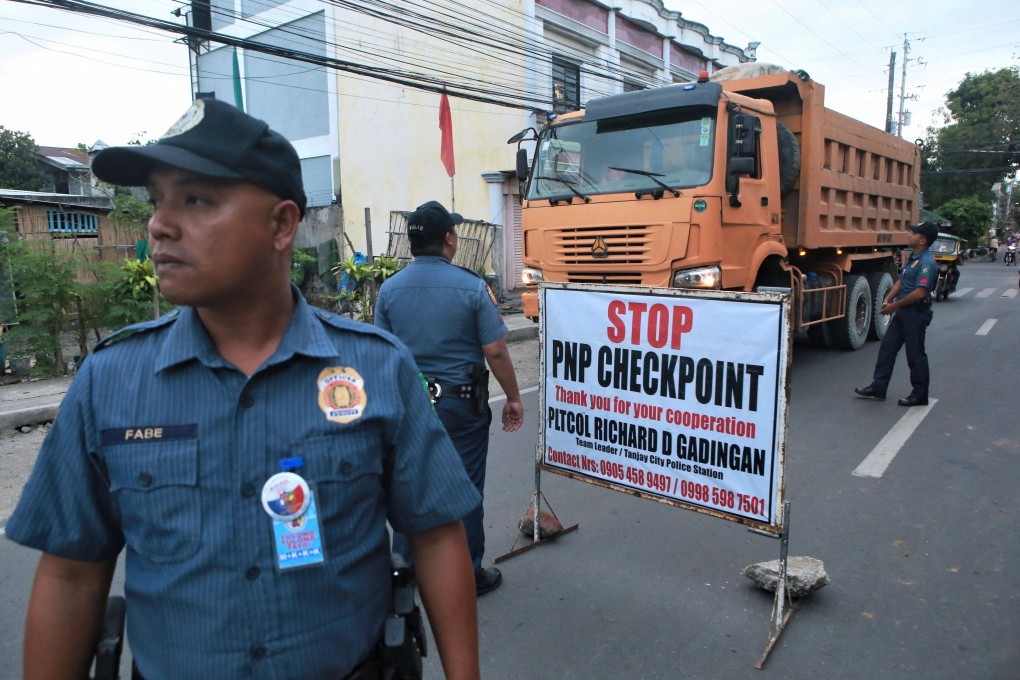 Police at a checkpoint in the Philippine province of Negros Oriental, hours after Governor Roel Degamo and five others were killed by unknown gunmen. Photo: AFP
