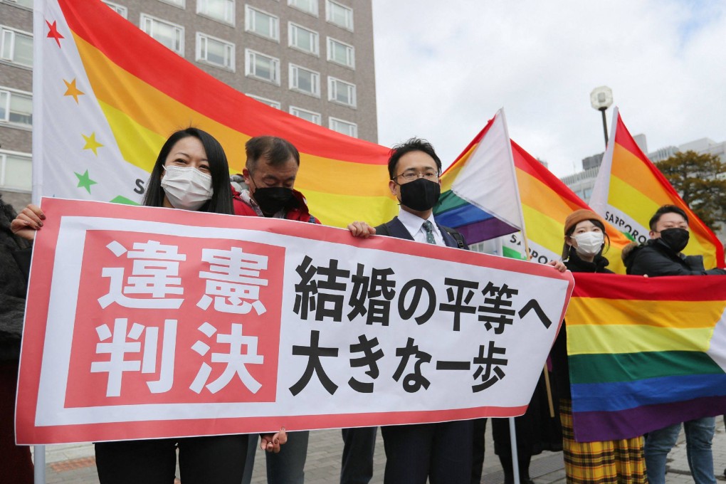 Supporters hold the “unconstitutional decision” flag in front of the Sapporo District Court on March 17, 2021. Japan is the only Group of 7 nation that does not recognise same-sex marriage. Photo: AFP