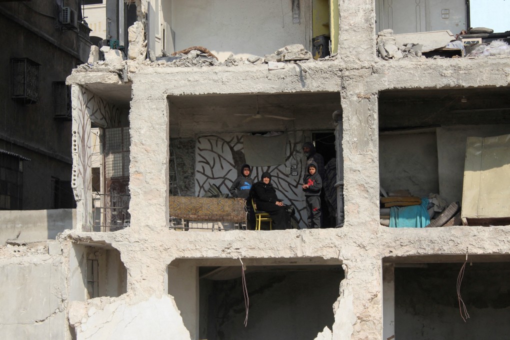 Amina Raslan with her son and grandchildren in her son’s damaged home in Aleppo in the aftermath of February’s deadly earthquake in Syria. Aid flights are being restricted by an Israeli attack on a Syrian airport on Tuesday. File photo: Reuters