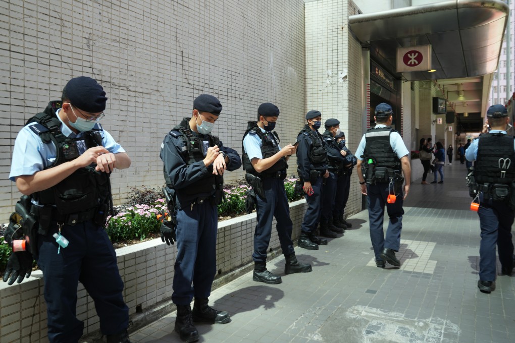 Police officers stand guard near Wan Chai MTR station on March 5. The Hong Kong Women Workers’ Association called off what would have been the first authorised rally in Hong Kong in three years, although the reason for the cancellation is unclear. Photo: Sam Tsang