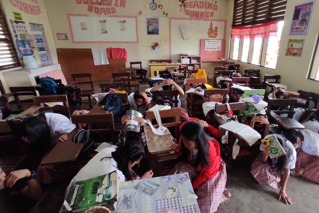Students try to take shelter inside their classroom after a 6.0-magnitude earthquake jolted the southern Philippines on Tuesday. A second quake hit a few hours later. Photo: Handout via AFP