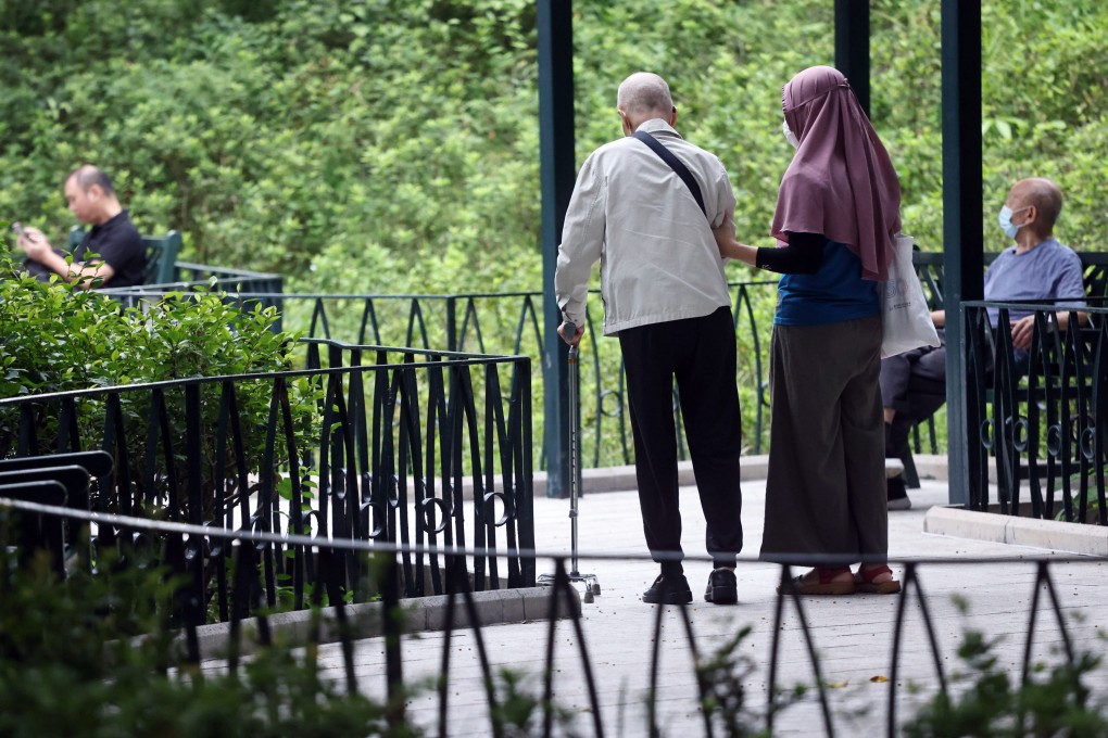 A senior citizen is accompanied by a domestic worker to a garden in Jordan in 2022. Photo: K.Y. Cheng