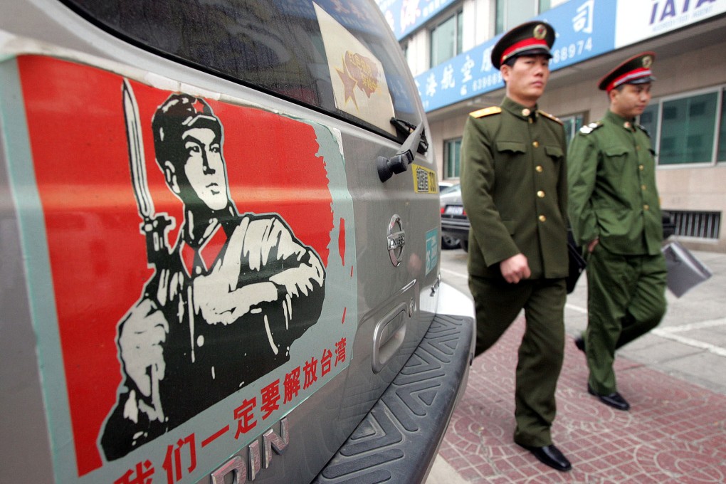 Chinese military officers walk past a car on a Beijing street bearing a sticker showing a map of China and Taiwan with a Chinese soldier and the words “We must take back Taiwan”. Pundits wonder what a reunified China would call itself. Photo: AP