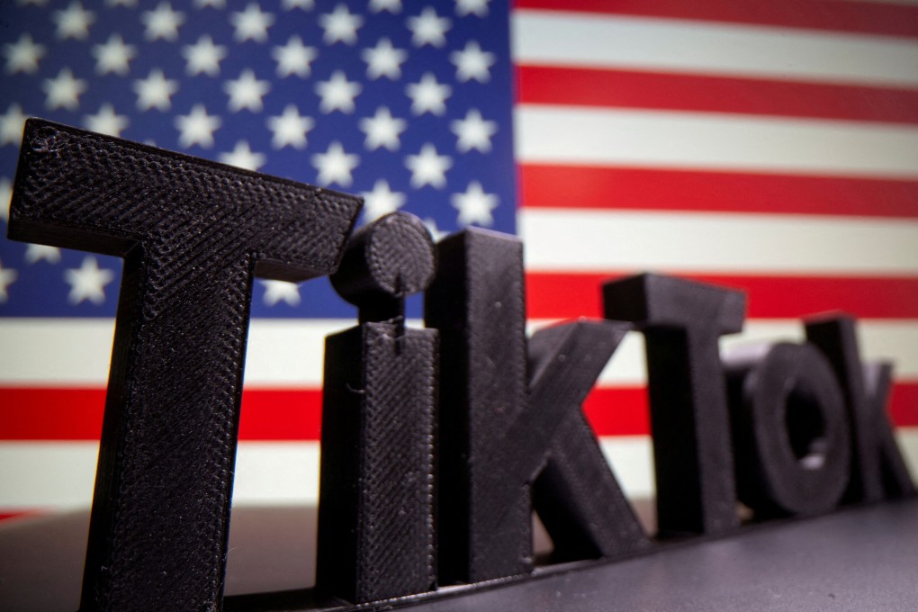 The TikTok logo is seen in front of the US flag. Photo: Reuters