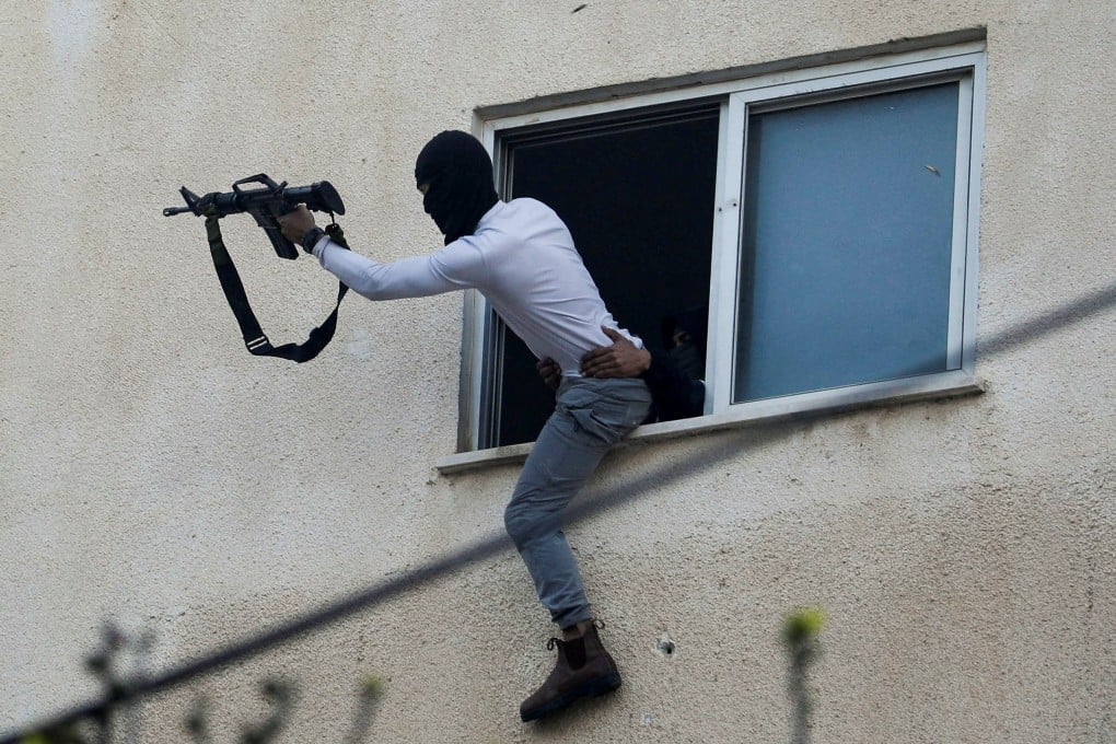 Palestinians clash with Israeli troops during an Israeli army raid in Jenin in the Israeli-Occupied West Bank. Photo: Reuters