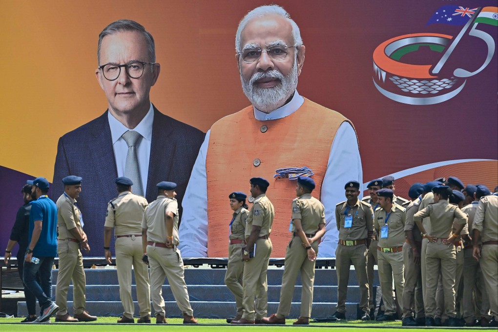 Police personnel stand next to a poster with the pictures of Australia’s Prime Minister Anthony Albanese (left) and his Indian counterpart Narendra Modi at the Narendra Modi stadium in Ahmedabad on Tuesday. Photo: AFP