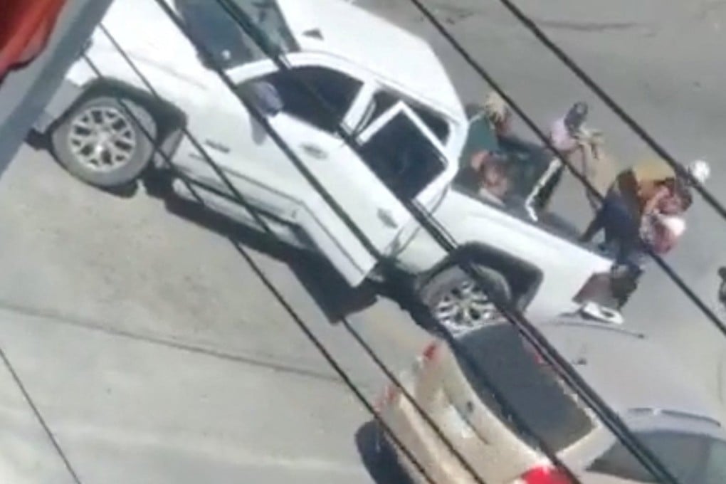 A woman is carried to the back of a white truck in a still image obtained from social media video that allegedly shows the kidnapping of Americans in Matamoros, Mexico on Friday. Photo: Reuters