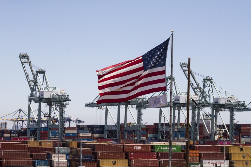 The US flag flies above containers at the Port of Los Angeles in California on July 7, 2022. The end of hyper-globalisation is creating the opportunity to right the wrongs of neoliberalism, but national security establishments in the world’s leading powers are steering the narrative towards conflict. Photo: EPA-EFE