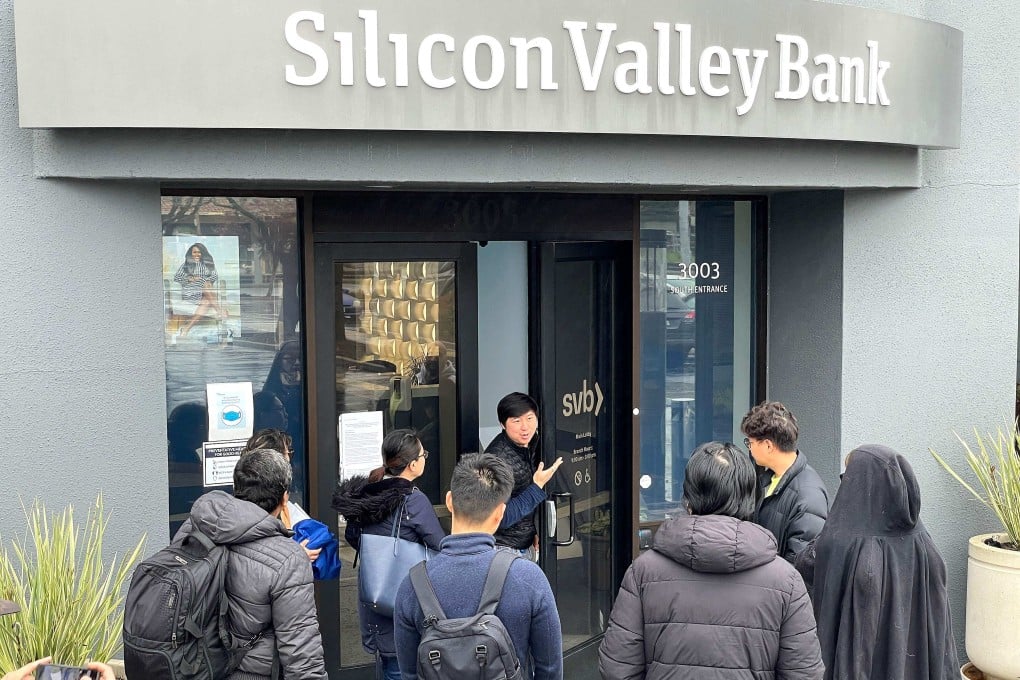 A worker tells people that the Silicon Valley Bank headquarters is closed in Santa Clara, California, on Friday. Photo: AFP