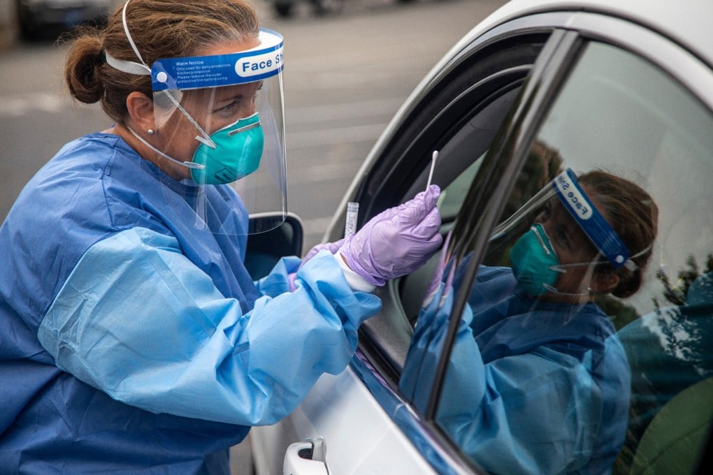 A worker performs a coronavirus test on a motorist in Burlington, North Carolina, in July 2020. Photo: TNS