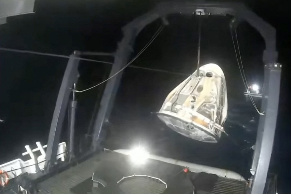 The SpaceX Crew-5 Dragon Endurance capsule is lifted off the water onto a recovery ship after splashdown off the coast of Florida on Saturday. Photo: Nasa TV/AFP