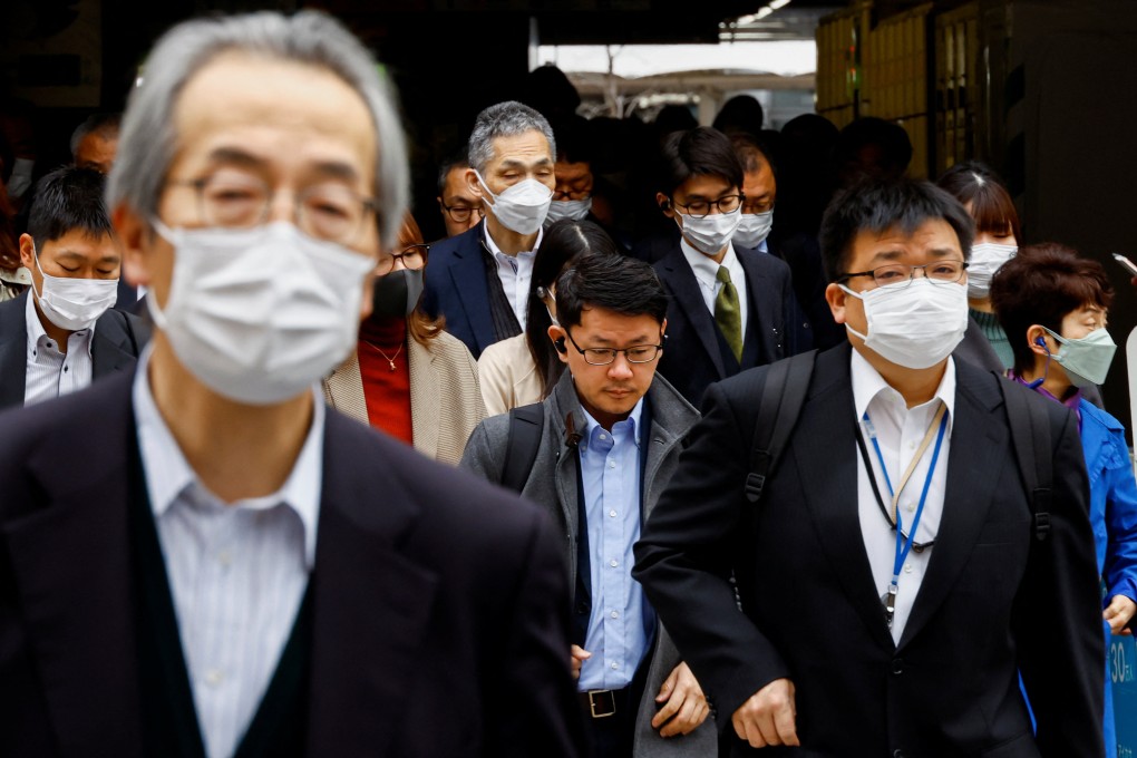 Commuters in Tokyo make their way to work on Monday, the first day of the Japanese government’s official relaxation of face mask guidance. Photo: Reuters