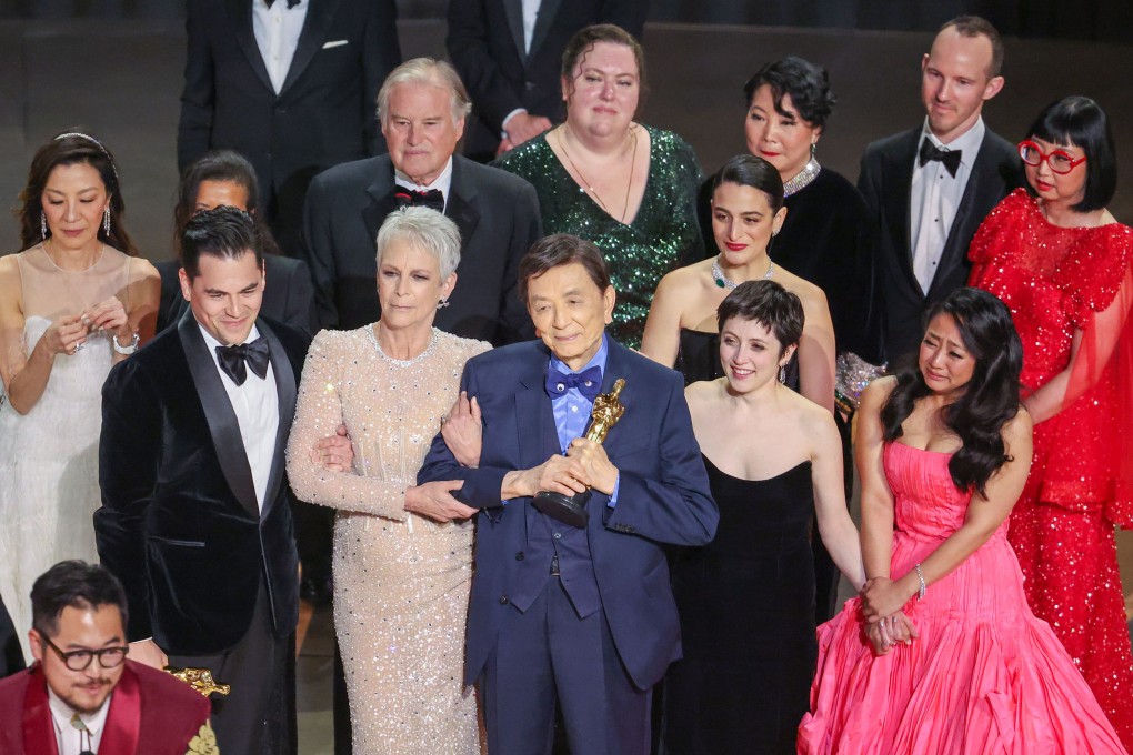 “Everything Everywhere All at Once” cast members including James Hong, 94 (front, centre, holding its Oscar for best picture), celebrate on stage at the Dolby Theatre in Hollywood. The film dominated Oscars night, winning seven awards. Photo: Myung J. Chun/Los Angeles Times/TNS