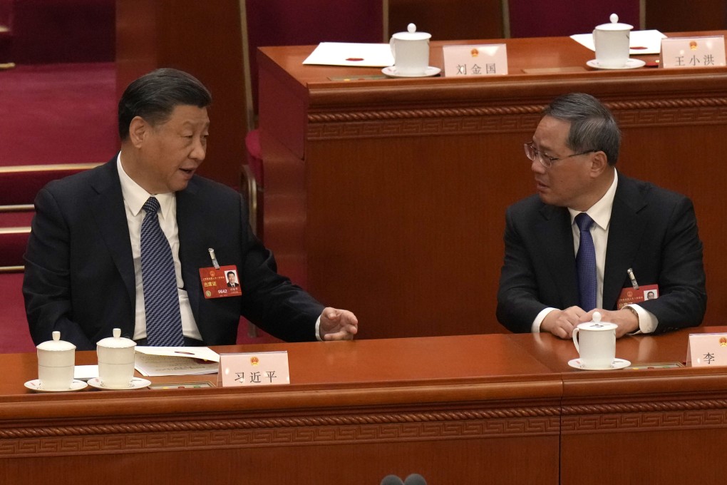 Chinese President Xi Jinping, left, chats with Chinese Premier Li Qiang during a session of China’s National People’s Congress (NPC) at the Great Hall of the People in Beijing on Sunday. Photo: AP