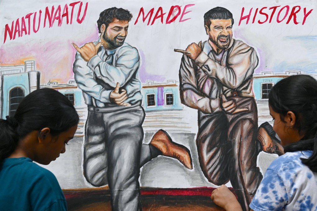 Art school students put the final touches to a painting of Indian actors N.T. Rama Rao Jnr. (left) and Ram Charan dancing to ‘Naatu Naatu’ in a scene from the film ‘RRR’ on Monday. Photo: AFP