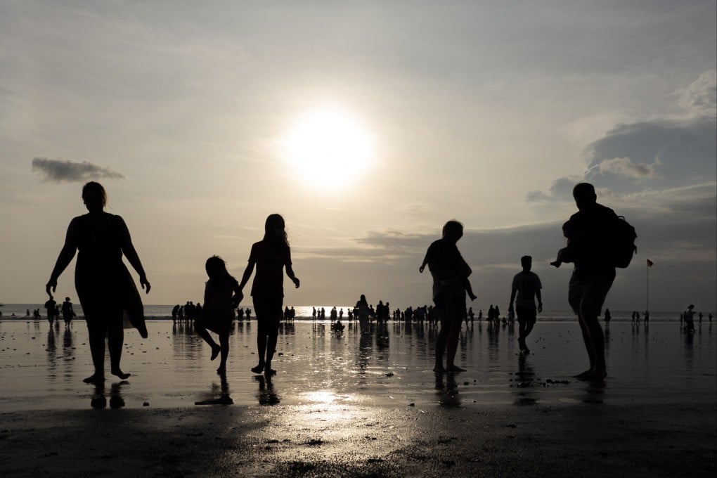 Tourists walk along Kuta Beach in Indonesia’s resort island of Bali. Bali’s governor said he had requested the cancellation of visas-on-arrival for Russian and Ukrainian citizens due to a series of violations. Photo: EPA-EFE