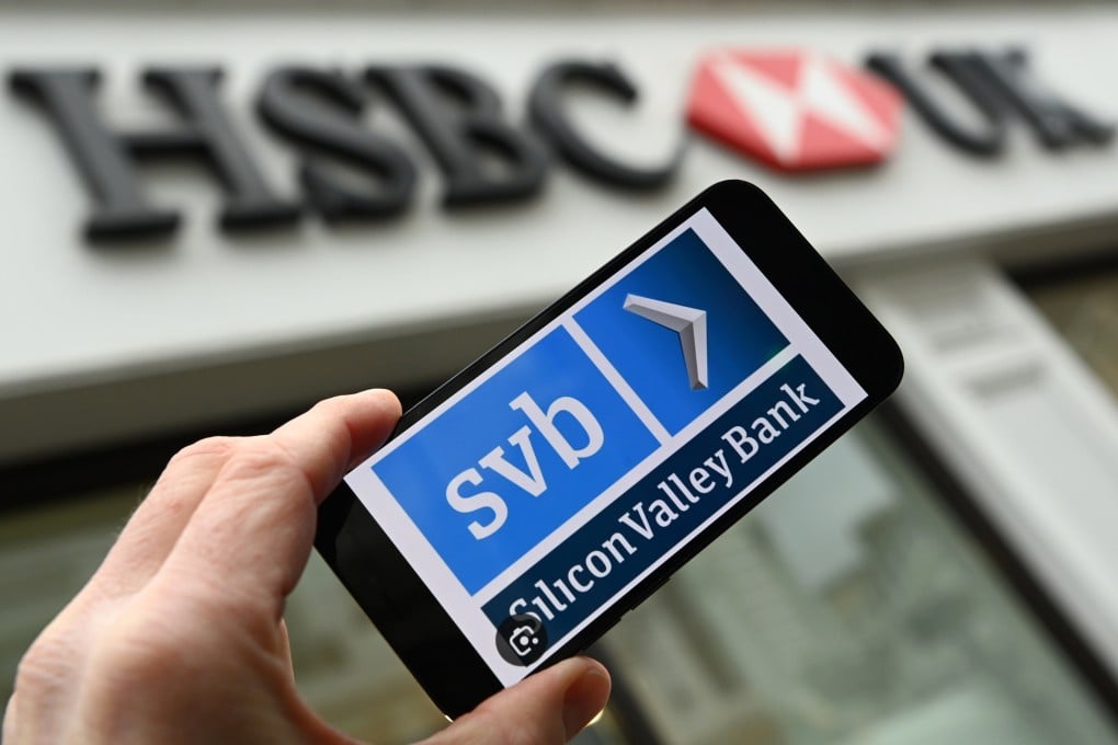 An SVB logo is shown on a smartphone outside a HSBC bank branch in London on March 13. Photo: EPA-EFE