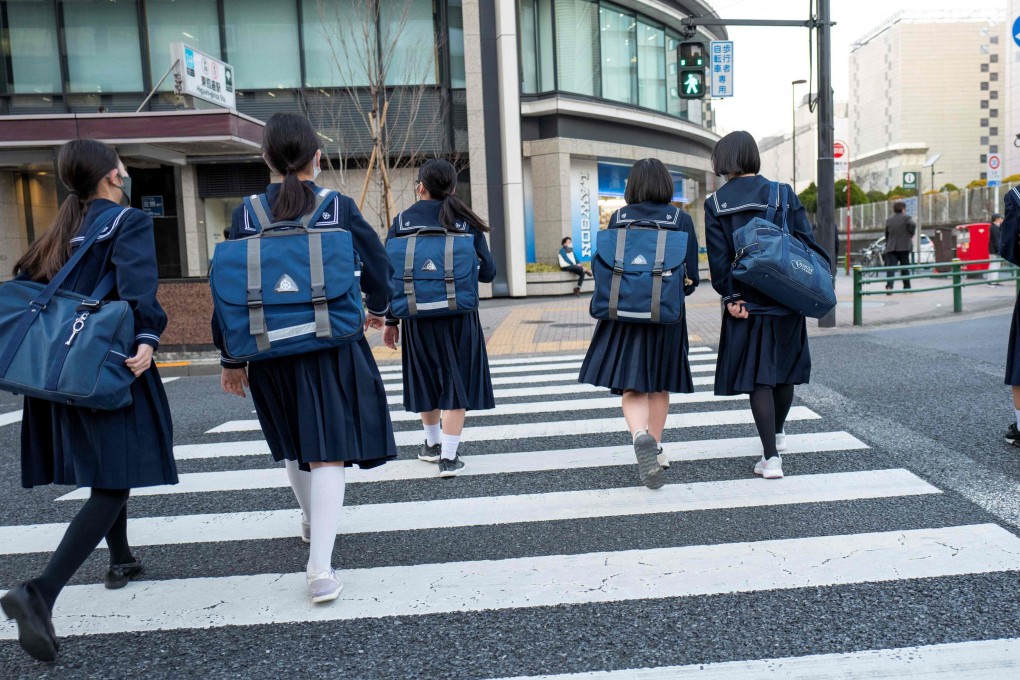 Junior high school students return home from school in Tokyo. A record 514 schoolchildren died by suicide in Japan last year. Photo: AFP