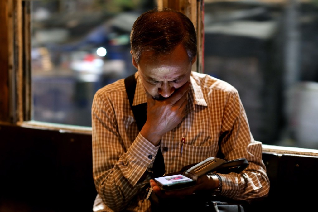 A man checks his smartphone while commuting on a tram in Kolkata. India has ramped up scrutiny of Chinese businesses in recent years. Photo: EPA-EFE