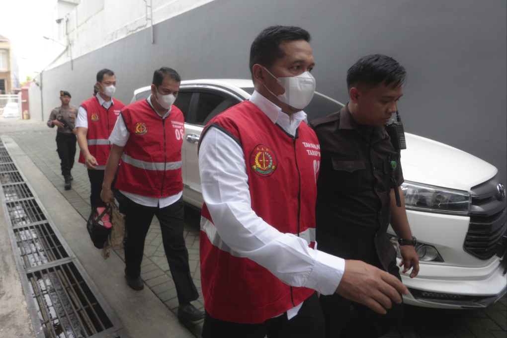 Police officers (from right) Bambang Sidik Achmadi, Hasdarmawan and Wahyu Setyo Pranoto are escorted by security guards to a courtroom for their sentencing hearing at a district court in Surabaya, Indonesia, on Thursday. Photo: AP