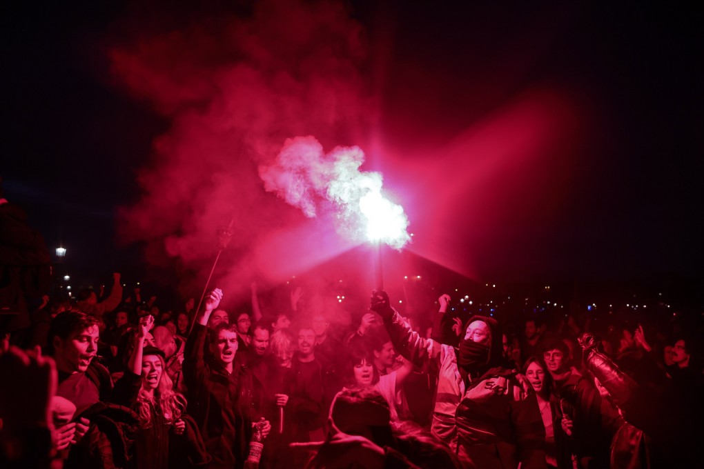 Protesters light flares near the National Assembly in Paris, France on Thursday after President Emmanuel Macron raised the retirement age from 62 to 64. Photo: EPA-EFE