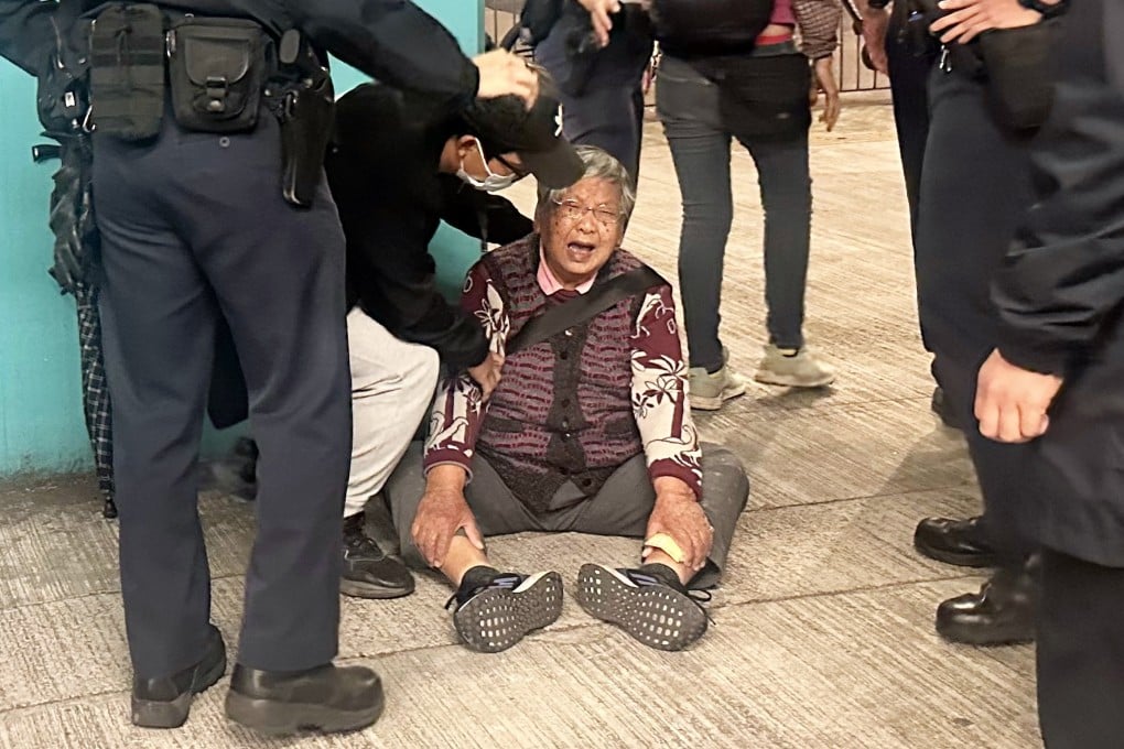Ninety-year-old licensed street hawker Chan Tak-ching cries after having her roast chestnut trolley confiscated. Photo: Natalie Wong