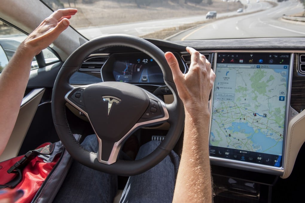 A test driver uses a Tesla Model S car equipped with autopilot and GPS in Palo Alto, California, in October 2015. The advent of technologies such as GPS and AI chatbots has raised fears among some that their increased use will lead to essential human skills atrophying. Photo: Bloomberg