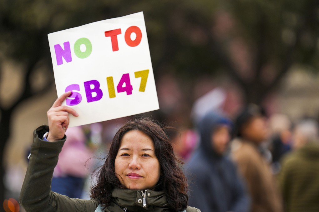 Liu Yang holds a sign in opposition to Texas Senate Bill 147 during a rally on January 29, 2023, in Dallas, Texas. The original bill proposed outlawing real estate/property ownership by people from China, Iran, North Korea and Russia. Photo: The Dallas Morning News/TNS