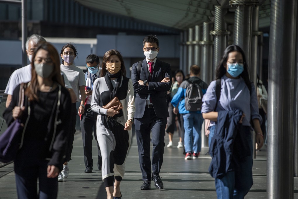 Pedestrians walk on a footbridge in Hong Kong in October 19, 2022, when Chief Executive John Lee unveiled measures to address the city’s talent crunch. Photo: AP