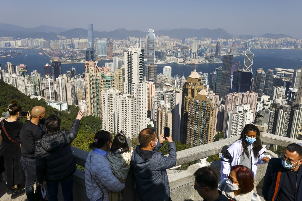 People admire the Hong Kong skyline at The Peak. Chinese President Xi Jinping has stressed the city’s long-term prosperity is inseparable from the country’s national development. Photo: Dickson Lee