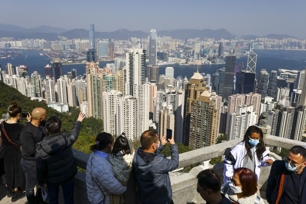 People admire the Hong Kong skyline at The Peak. Chinese President Xi Jinping has stressed the city’s long-term prosperity is inseparable from the country’s national development. Photo: Dickson Lee