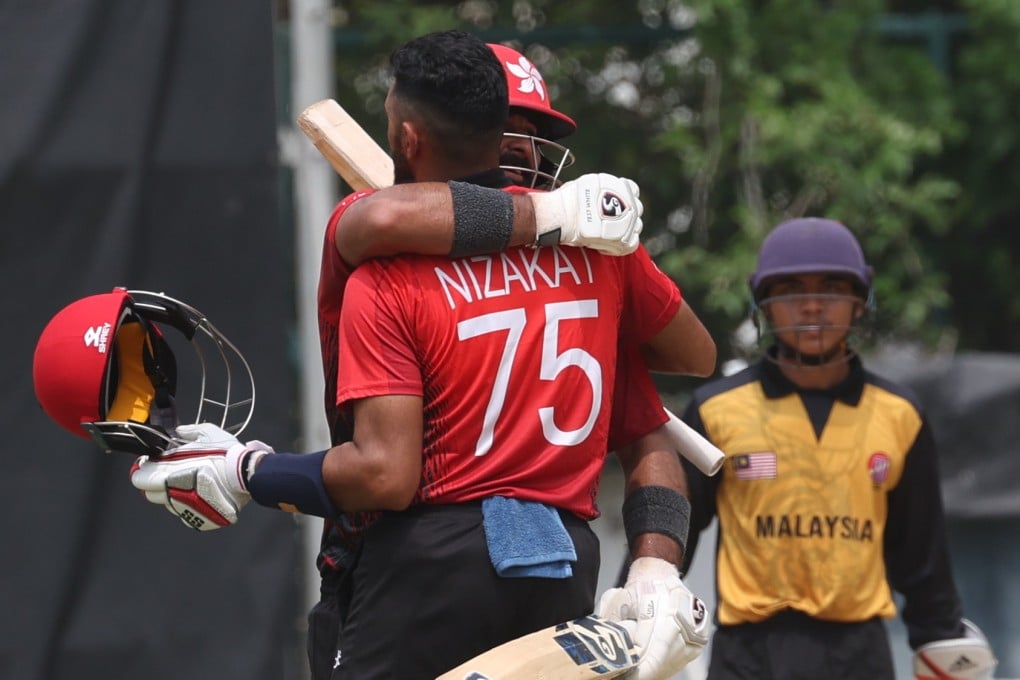 Hong Kong skipper Nizakat Khan is hugged by teammate Anshuman Rath after scoring a century against Malaysia. Photo: Yik Yeung-man