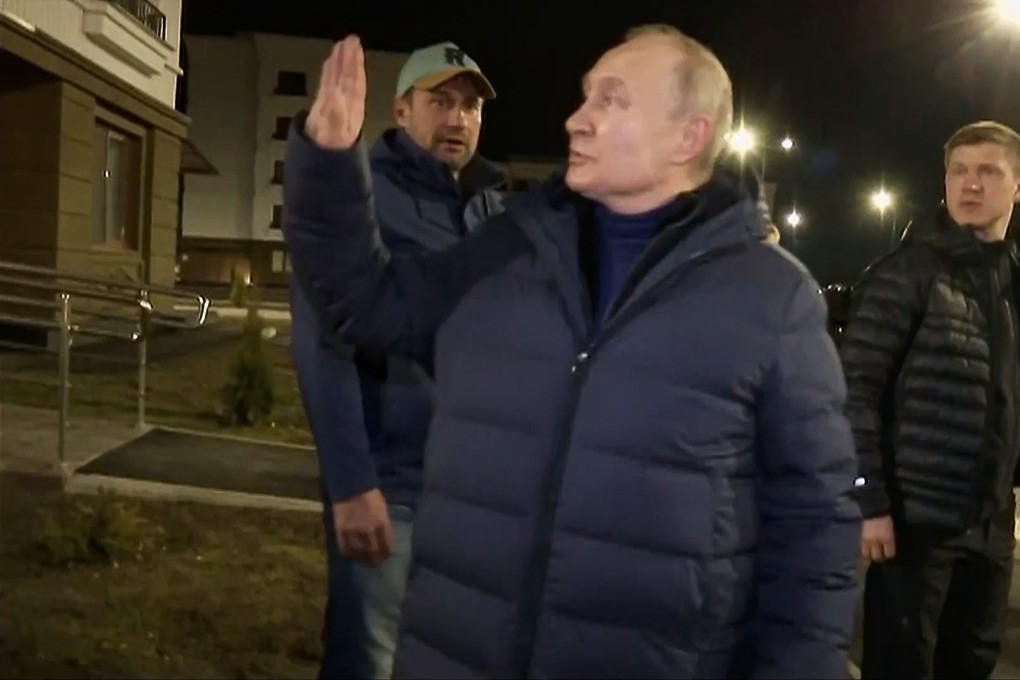 Russian President Vladimir Putin waves to residents during his visit to Mariupol in the Moscow-controlled Donetsk region of Ukraine. Photo: from video footage, via AP