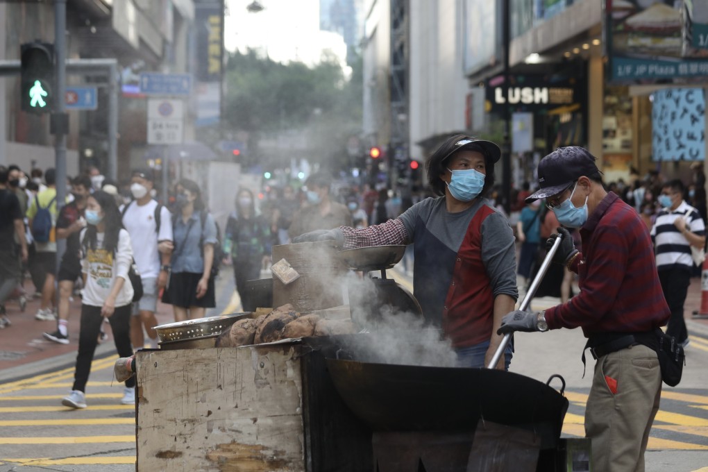 Street hawkers sell roast sweet potatoes and chestnuts in Causeway Bay in 2022. Photo: Xiaomei Chen