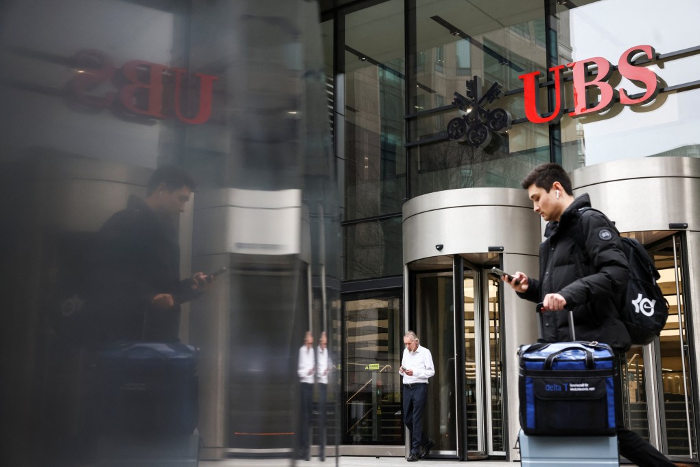 A person walks past the entrance of the UBS’s offices in London on March 20, 2023. Photo: Reuters