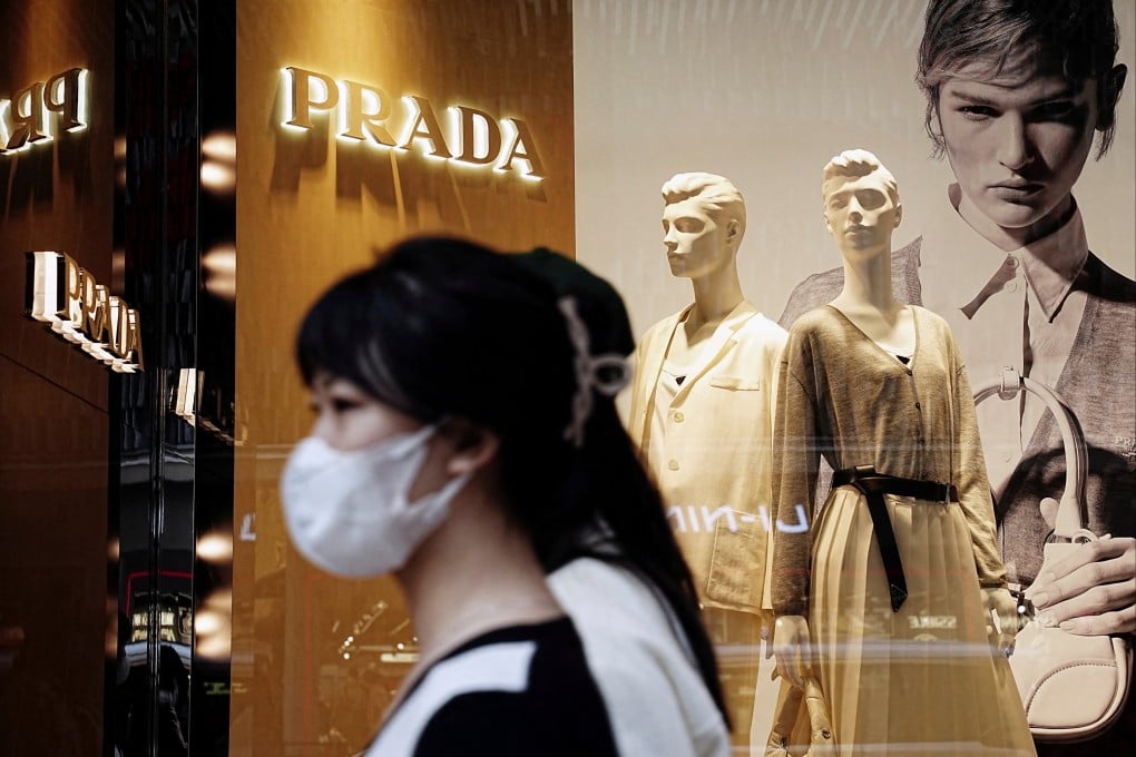 Shoppers walk past a Prada luxury store in Tsim Sha Tsui on February 15. Photo: Reuters